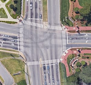 Four-way intersection with crosswalks, pictured from above.